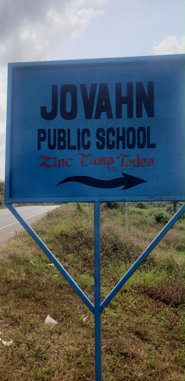 Roadside sign pointing to Jovan Public School, Zinc Camp, Todee